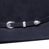 Close-up of a dark blue hat with silver buckles on a white background