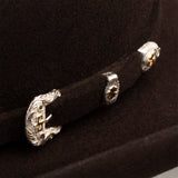 Three silver earrings with intricate designs on a black background