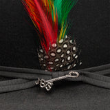Black hat with colorful feathers and a decorative band on a dark background