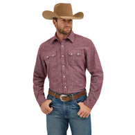 Man wearing a maroon button-up shirt, blue jeans, and a brown cowboy hat on a white background