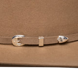 Close-up of a brown tan belt with silver buckles on a matching brown background